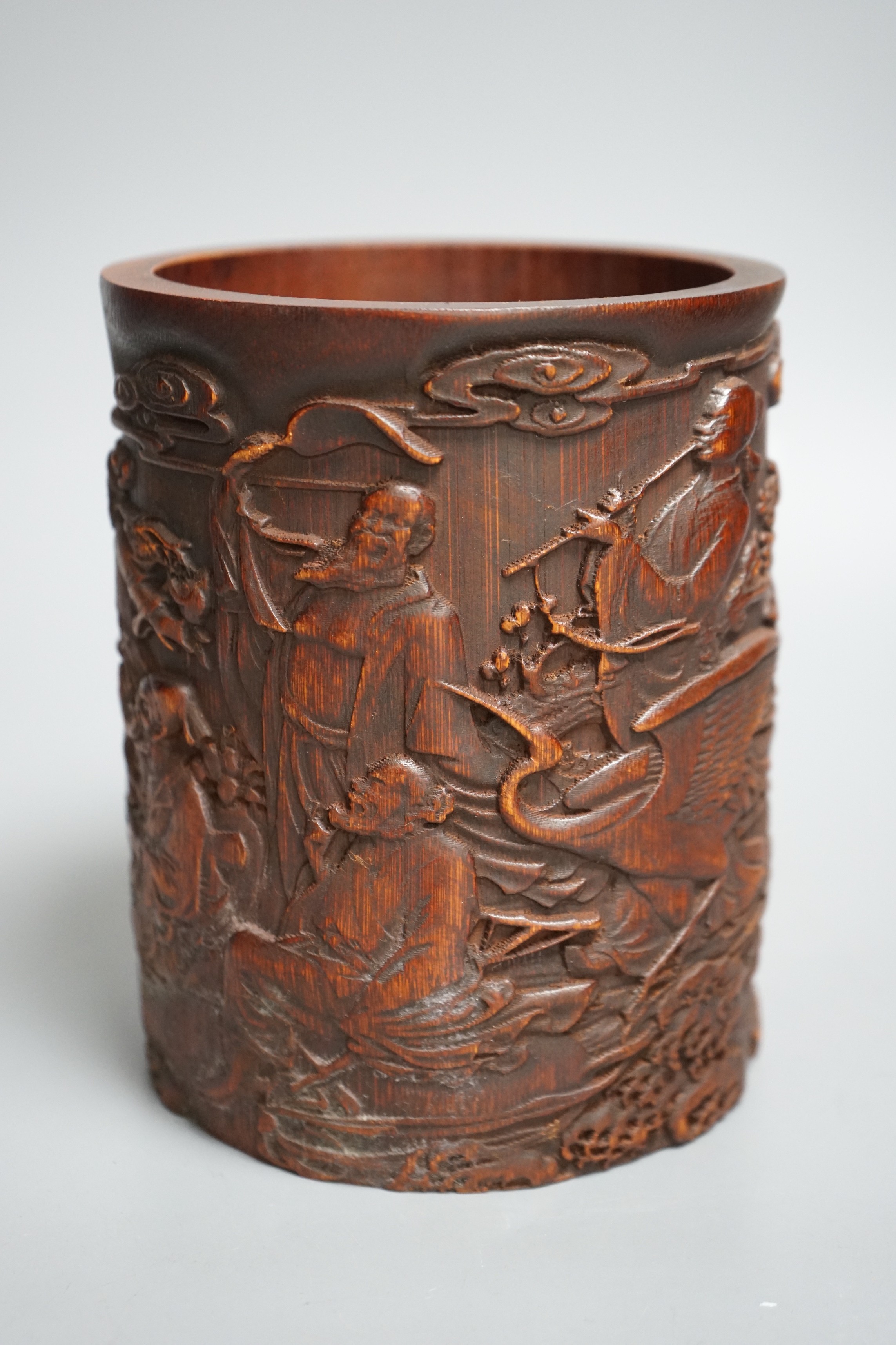 A Chinese 'immortals' carved bamboo brush pot, 16cm